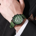 Detail of green quartz sports watch with silicone strap worn on male model wrist - Green Strap Black Case