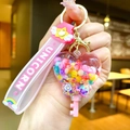 Detail of cute heart strawberry candy sand bottle keychain with pink unicorn wristlet - Glow-in-the-dark Rainbow Candy Beans [heart-shaped Key]