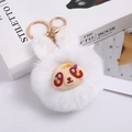 White plush bunny head keychain with gold hardware on a stylish fashion book - Bear / White