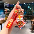 Leuke cartoon leeuwendans kat sleutelhanger van levendig rood en geel silicone. - B444-3 Rood Stoffen Draak