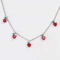 Detailed view of silver chain necklace with red zircon heart charms and green leaf accents - Silver Strawberry Necklace
