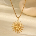 Close-up of gold plated sun god pendant with twisted chain on a minimalist stone base - Smiling Sun God - Twist Chain