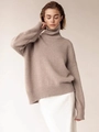 Detail of chunky turtleneck knitwear showing soft oat-colored texture and ribbed cuffs - S / Camel
