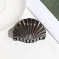 Detailed macro view of bronze shell hair claw with matte texture and gripping teeth - Small / Coffee