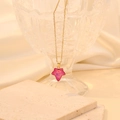 Macro detail of pink star-shaped maple leaf pendant on a delicate gold link chain - Rose Red