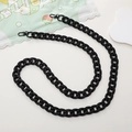 Detail view of a black acrylic crossbody phone chain with metal clasps on white background - Crossbody Chain / Matte Black