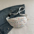 White canvas waist bag with colorful polka dots over a denim jacket lifestyle shot - White