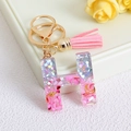 Pink glitter resin letter H keychain with golden fringe and celestial metal sequins - Letter H / Pink