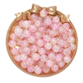 Pink crackle glass beads for DIY jewelry making displayed on a gold tray with a bow - 50Pcs/10mm / Cracked Opal Style Bead - Pink Yellow