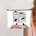 Détail de la trousse de maquillage en toile avec motifs de chats et notes de musique - Silhouette de Chat sur Portée (jiaying0017)