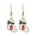 Detail view of red Christmas stocking earrings with golden metal hooks and letter B decoration - Sock #37