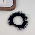 Detail of checkered plaid scrunchie with lace edge and elastic hair tie on a white surface - Black with Black & White Plaid