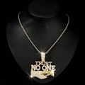 Macro detail of gold TRUST NO ONE hip hop pendant with sparkling diamonds and cuban chain - Gold Pendant with 20inch Twist Chain