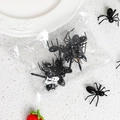 Close-up of black ant-shaped plastic fruit picks and mini animal skewers for kids lunch - Ant 12 Pieces OPP Bag