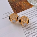 Detailed macro view of gold-tone hollow flower earrings with black and white enamel fill - 17# Hollow Flower Sphere - Gold-Black-White