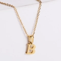 Macro view of gold plated letter B pendant showing polished finish and fine chain detail - Letter B