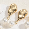 Macro detail of gold-tone geometric earring with white pearl on white stone texture - Smooth Pearl Stud Style (ES2330-4)