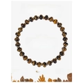Macro shot of tiger eye beaded bracelet featuring natural stones on a white gift card - Tiger Eye Bracelet