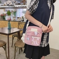 Détail d'un sac bandoulière en toile rose avec motifs de lapin mignons sur un modèle - Rose Avec Pendentif Ours