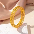 Elegant gold hollow filigree bangle with solar floral patterns on silk and stone base - Sun