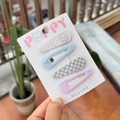 Detailed view of four colorful candy-colored hair clips held in hand against greenery - Pink Blue Stripe - Westie BB Clips (4pcs)