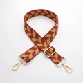 Detail of red woven bag strap with golden chevron pattern and adjustable metal hardware - J44-A9-Red Yellow Arrow