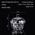 Small pumpkin-shaped glass storage jar with lid and vertical ribbed texture on black background - Pumpkin Glass Jar - Small