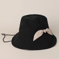 Detail of black cotton sun hat featuring a beige bow accent and adjustable chin strap - Black