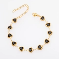 Detail of gold-plated heart-shaped links with black stones and lobster clasp on bracelet - Gold + Black