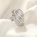 Detailed view of silver hammered stainless steel ring on white silk background - Irregular Stripe / Silver