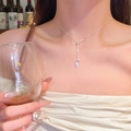 Silver bow necklace with pearl and square pendant on a snake chain worn by a woman - Square Tag Pearl Tassel (X1707) / Silver/Pearl White