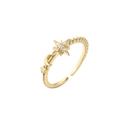 Macro shot of adjustable gold star and moon ring with zircon pavé and spiral band - Gold Star