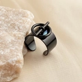 Detailed close-up of a wide gold-plated stainless steel ring with a unique ring and bar design - Black