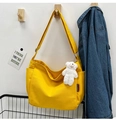 Detail view of yellow canvas tote bag with adjustable strap and plush bear charm decor - With Bear Pendant / Yellow