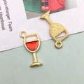 Detail of red enamel wine glass charm with golden metal frame and honeycomb texture back - Wine Glass (10987)