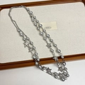 Detail of layered necklace with grey pearls and star pendants on a display tray - Pearl Pentagram Necklace