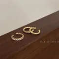 Three-piece golden C-shaped ear cuff set with zircon studs and twisted metal textures - 3-Piece Set / Gold
