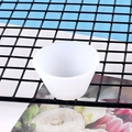 Detail of 100ml silicone measuring cup with scale on black metal mesh rack - Unpackaged Small Distribution Cup 60-455