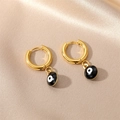 Detailed close-up of golden stainless steel hoop earrings with black evil eye pendants - Black