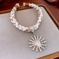 Bohemian braided cord necklace featuring a metallic silver sunburst pendant design - Silver Sun Pendant Woven Necklace