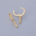 Detail of gold huggie hoop earrings with cascading triple star charms and clear zircon stones - Star Dangle - Gold