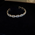 Detailed macro view of gold-tone chain link bracelet with sparkling pave zircon settings - Silver Chain Bangle