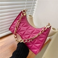 Macro view of rose pink quilted leather bag with chunky gold metal chain detail - Rose Red