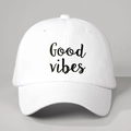 Close-up of white baseball cap with black Good Vibes embroidery and breathable eyelets - White