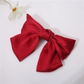 Elegant oversized dark red satin bow hair clip on a clean white background with a daisy - Burgundy