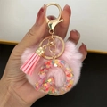 Detail of pink faux fur pompom and resin letter O keychain with colorful heart sequins - Letter Q
