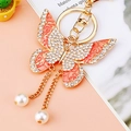 Orange butterfly keychain with colorful crystals and pearls on a gold-plated metal base - Pink Tassel Butterfly