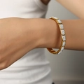Elegant gold-tone watchband link bracelet with shimmering pavé crystal square modules - Gold