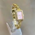 Detail of a square gold watch with pink dial and diamond-set bezel on a chain strap - Pink