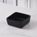 Minimalist square black matte ceramic snack bowl on a grey marble tabletop finish - Black